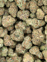 Top Gun hybrid exotic smalls showing crystal trichomes and bright orange hairs | August Cannabis Club